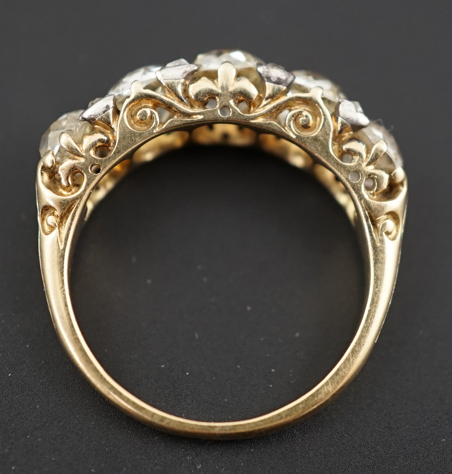 A Victorian 18ct and graduated five stone old round cut diamond set half hoop ring